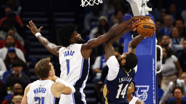 Magic's Jonathan Isaac blocks Pelican's Brandon Ingram.